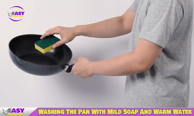 Washing The Pan With Mild Soap And Warm Water